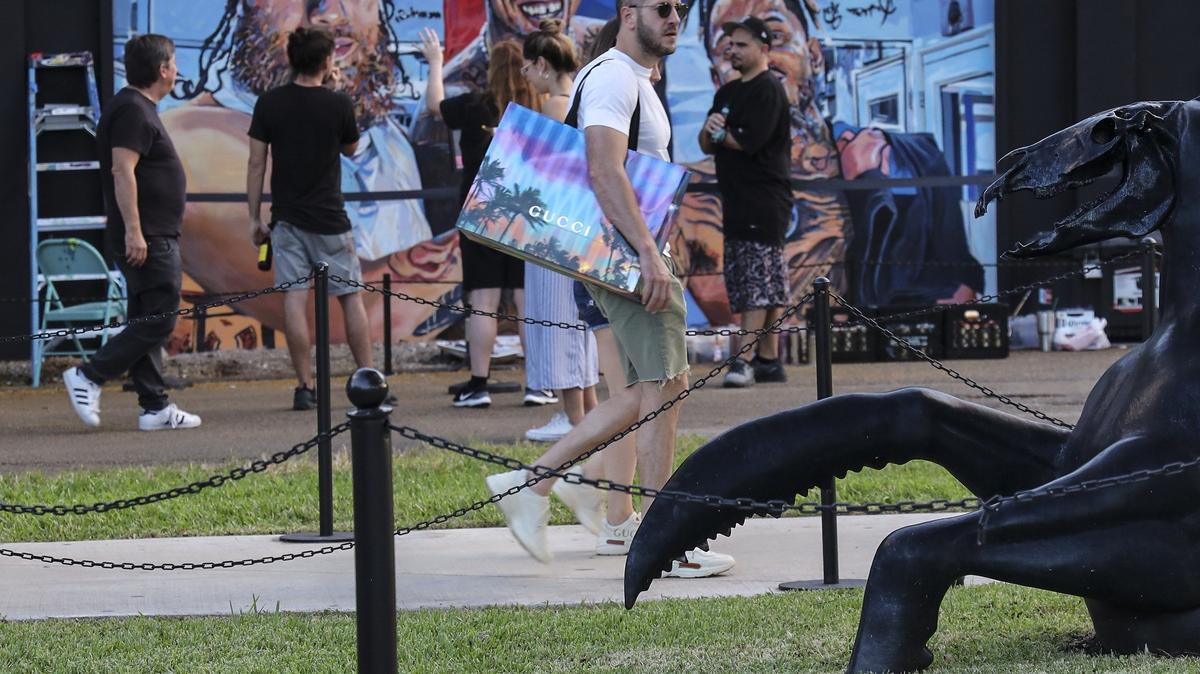 Local, national, and international visitors walk through the outdoor gallery of murals on Sunday, Nov. 25, 2019, as Wynwood Walls celebrated its 10th anniversary during Miami Art Basel.