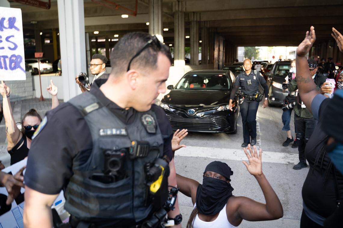 At a Black Lives Matter protest in Fort Lauderdale on May 31, Ofc. Steven Pohorence turns to look at a kneeling young woman just moments before shoving her in the head.