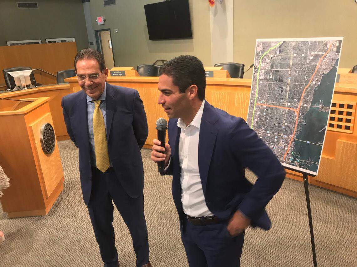 Former Miami Mayor Xavier Suarez (left) and his son, the current Miami mayor, Francis Suarez (right), discuss potential stops for Tri-Rail at Miami City Hall on Nov. 1, 2019.