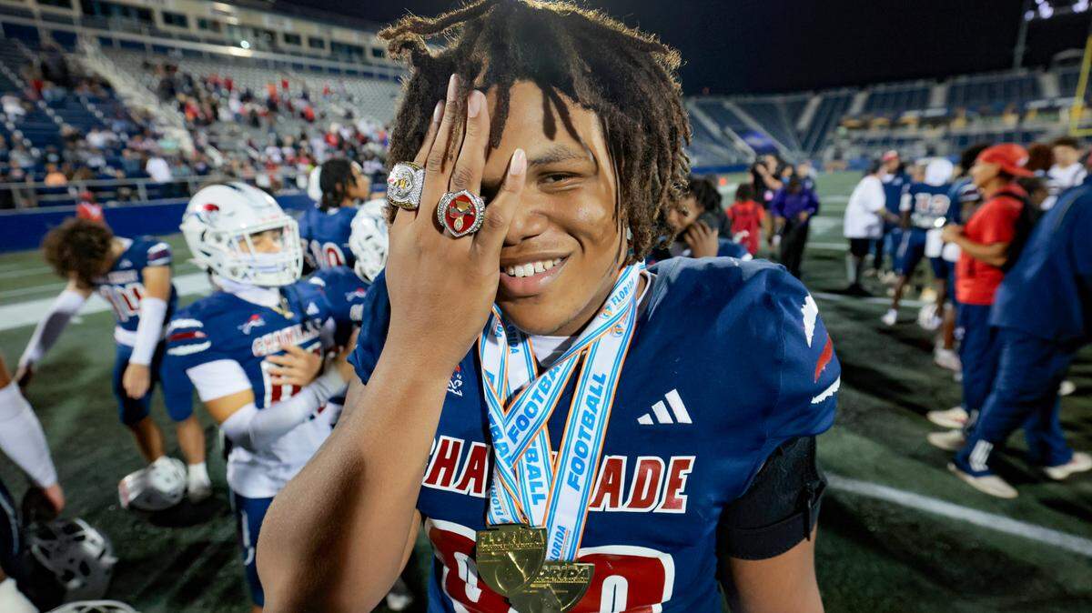 Chaminade-Madonna’s Donta Simpson (90) holds up his State Championship rings as he celebrates with teammates after defeating Clearwater Central Catholic in the Florida High School Football State Championships - Class 1A game at Pitbull Stadium on the campus of Florida International University in Miami, Florida, on Wednesday, December 11, 2024.