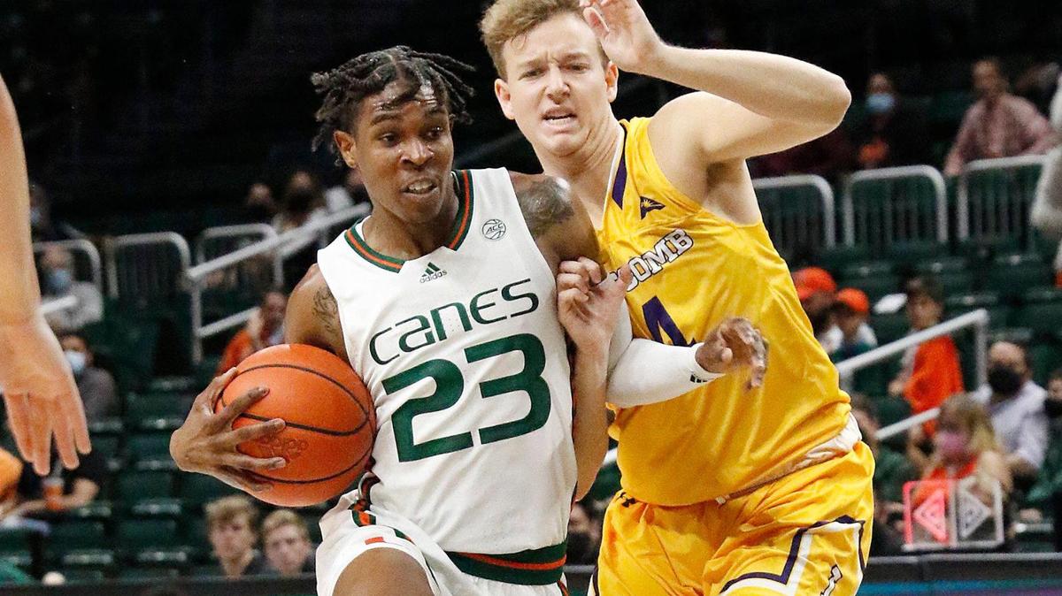 UM Hurricanes Kameron McGusty (23) and Lipscomb Bisons Tanner Shulman get a little to physical during basketball game on December 8, 2021 at Watsco Center in Coral Gables. Andrew Uloza / for THE MIAMI HERALD