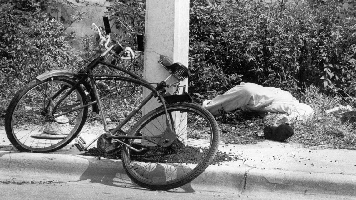 The body of Carl R, Brown lies in the bushes after he left eight men and women dead and three others wounded at Bob Moore’s Welding and Machine Service, 3147 NW North River Dr. during a shooting rampage in August of 1982. Brown was killed when an outraged motorist who knew the victims deliberately crushed Brown against a concrete light pole with his car. Brown killed owner Bob Moore’s mother, Ernestine Moore, 67; his uncle, Mangum Moore, 78, the bookkeeper; Carl Lee, 47, the manager; Martha Steelman, 29, a secretary; Lonie Jeffries, 53, a crane operator; Juan Trespalacios, 38, a machinist; Pedro Vasques, 44, the shop foreman; and Nelson Barrios, 46, a welder.