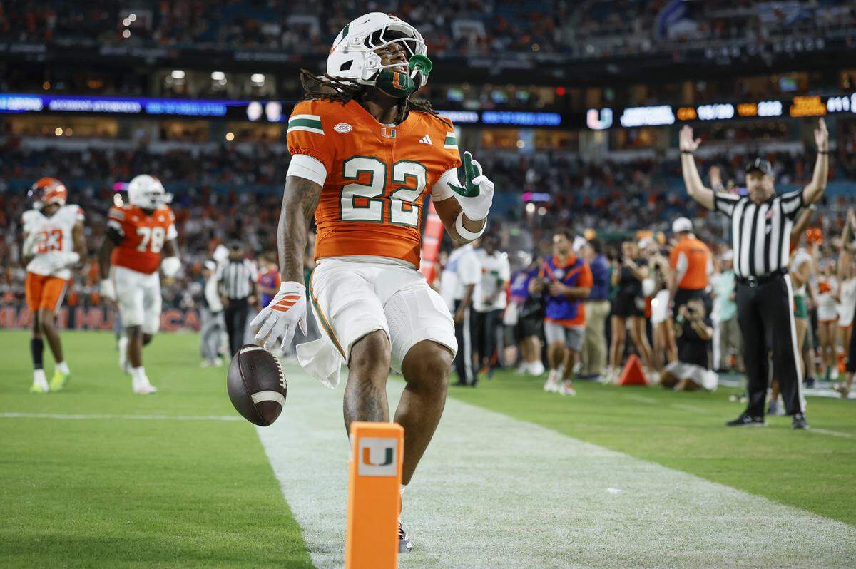 Miami Hurricanes running back Girard Pringle Jr. (22) scores in the second half of an NCAA football game against the Syracuse Orange at Hard Rock Stadium in Miami Gardens, Florida on Saturday, November 8, 2025.