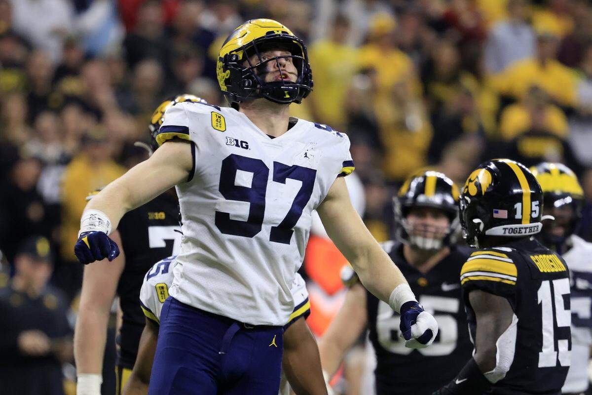 Aidan Hutchinson #97 of the Michigan Wolverines reacts after a sack during the second quarter in the Big Ten Championship against the Iowa Hawkeyes at Lucas Oil Stadium on December 04, 2021 in Indianapolis, Indiana.