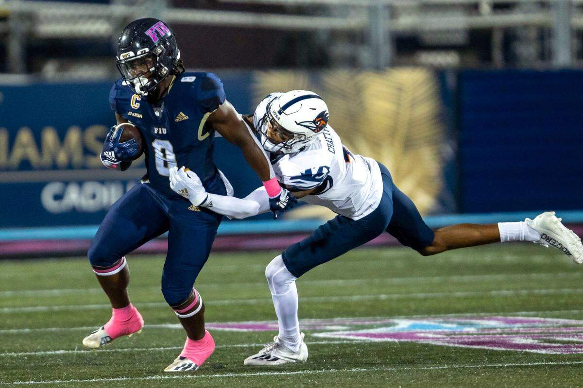 Florida International University running back Lexington Joseph (8) runs the ball while chased by Texas San Antonio safety Clifford Chattman (4) during the second half of an NCAA Conference USA football game at Riccardo Silva Stadium in Miami, Florida, on Thursday, September 14, 2022.