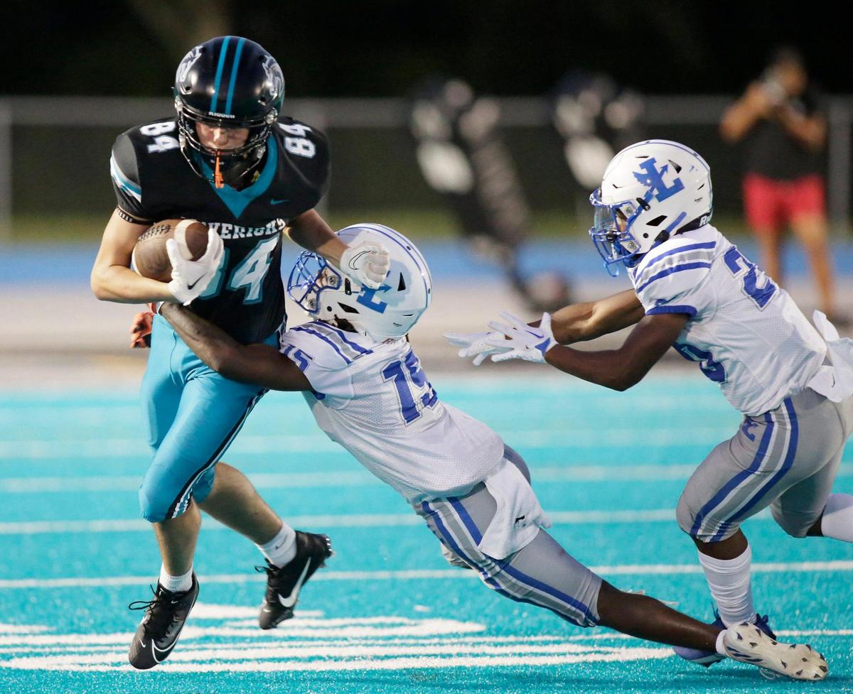 Archbishop McCarthy Mavericks Christian Lima (84) attempts to break free from Fort Lauderdale Flying L’s defender during the football game on Thursday, September 7, 2023 at Archbishop McCarthy HS in Fort Lauderdale. Andrew Uloza / for Miami Herald