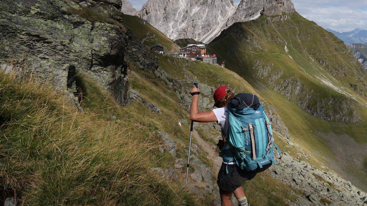 An alpine hiker approaches the Innsbrucker Hütte mountain hut in the Stubai Alps (Stubaier Alpen) mountain range on August 26, 2022 near Neustift im Stubaital, Austria.