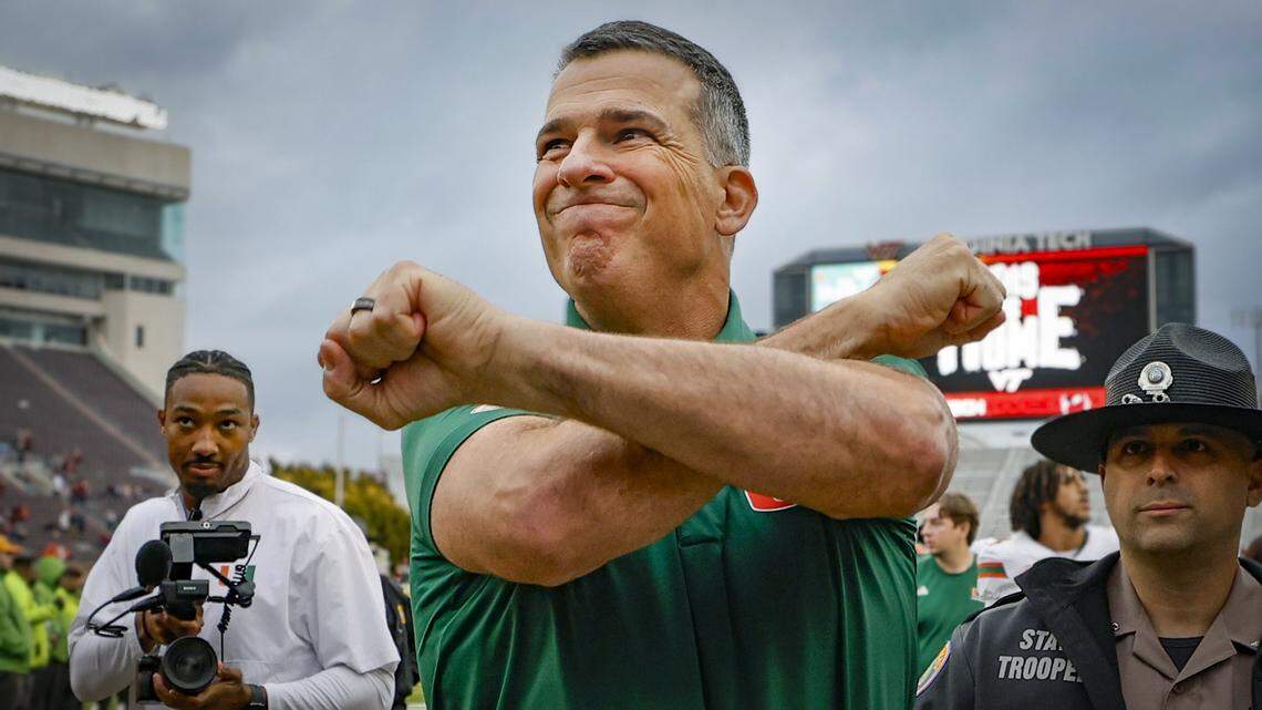 Miami Hurricanes head coach Mario Cristobal celebrates as he comes off the field after the Canes defeat the against the Virginia Tech Hokies at Lane Stadium in Blacksburg, Virginia, on Saturday, November 22, 2025.