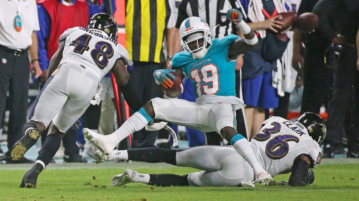 Miami Dolphins wide receiver Jakeem Grant (19) is tackled by Baltimore Ravens safety Chuck Clark (36) during second quarter of an NFL preseason football game at Hard Rock Stadium on Saturday, August 25, 2018, in Miami Gardens.