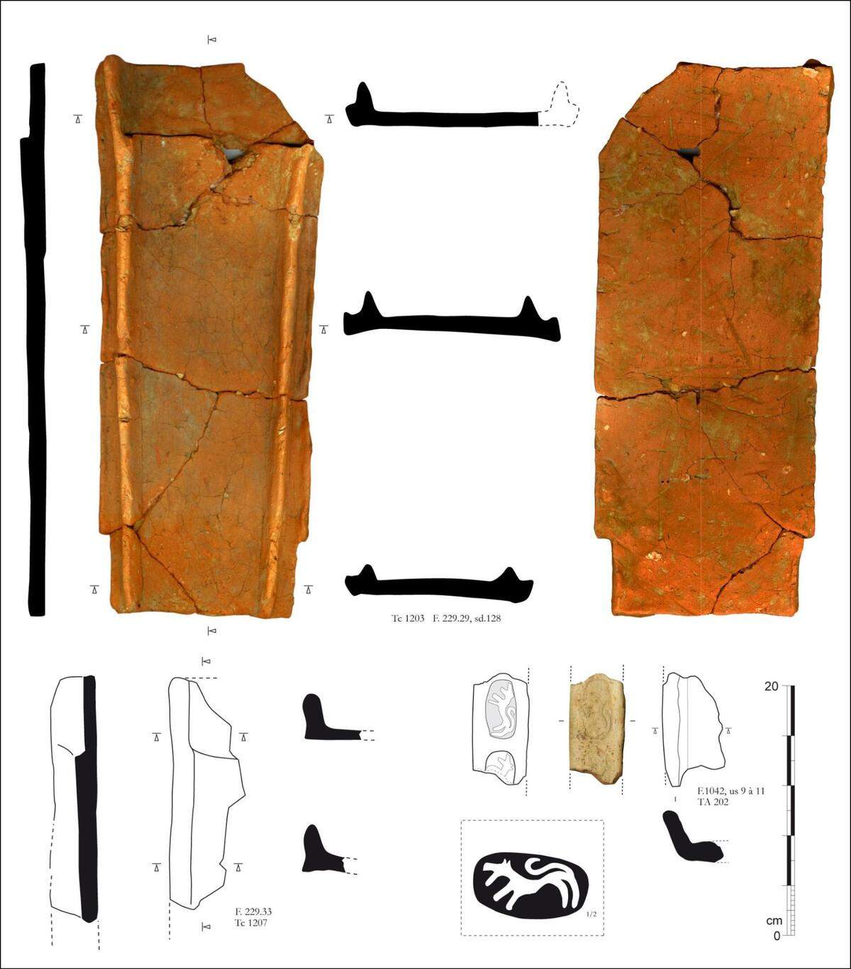 Some long, narrow tiles (top) and the signature wolf stamp (bottom) found at the workshop.