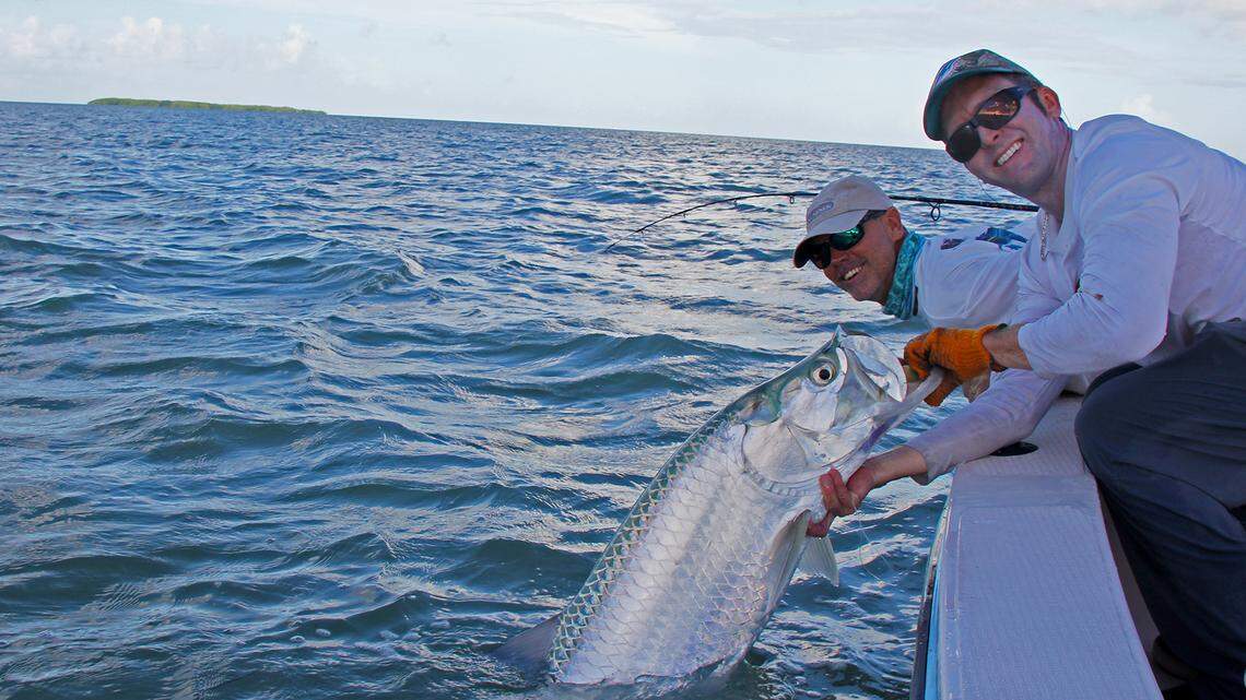 Capt. Rick Stanczyk, right, of Islamorada ready to release a tarpon caught by his angler.
