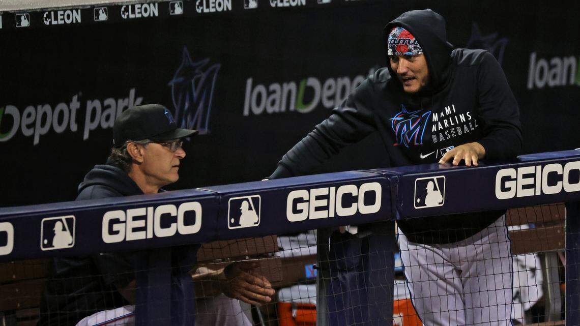 Miami Marlins manager Don Mattingly (8) talks with Marlins shortstop Miguel Rojas (19) during the ninth inning of their baseball game at loanDepot park on Friday, June 11, 2021 in Miami, Florida.