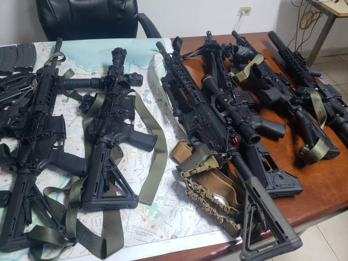 Haitian police say they found these weapons in the cars of several men driving around Port-au-Prince without license plates. Among those arrested were five Americans.
