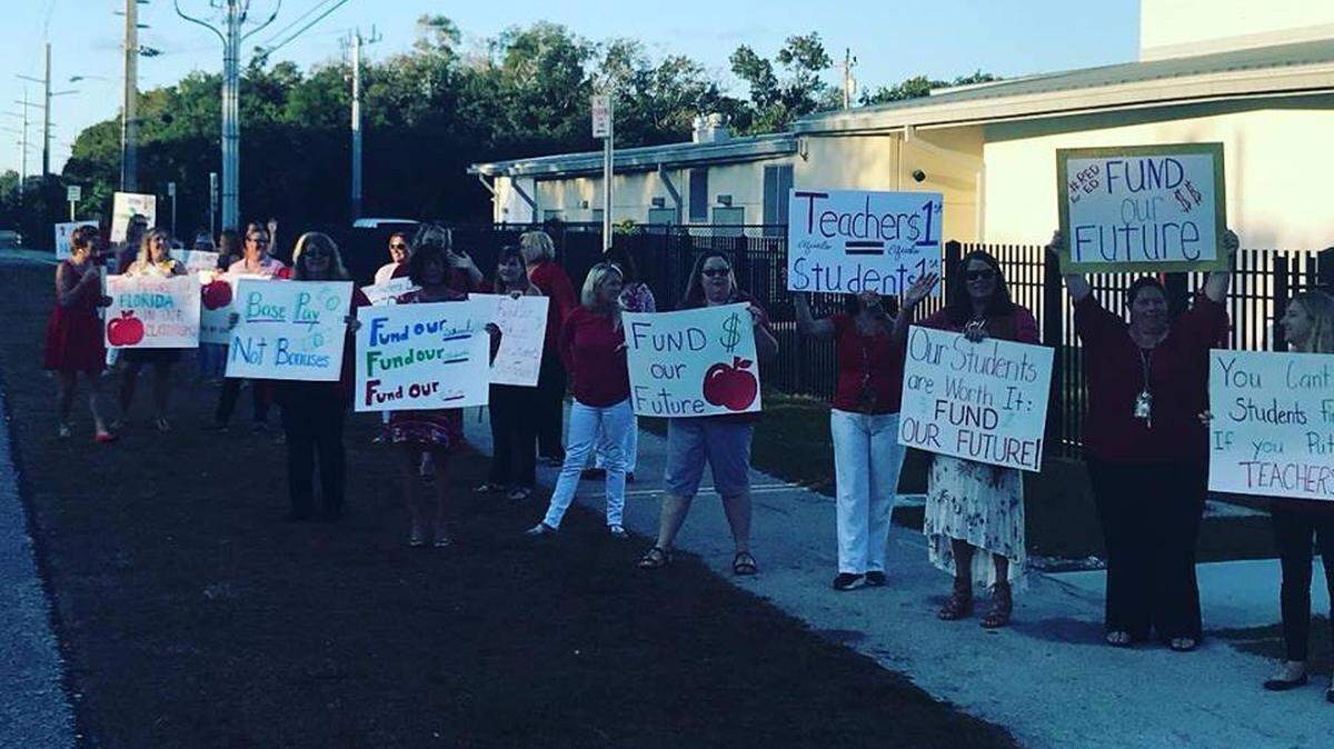 Teachers and their supporters stand outside of Plantation Key School in the Florida Keys Monday, March 4, 2018, to protest plans to increase public funding of private and charter schools.