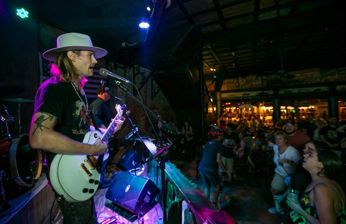People dance as David Bryce Warren performs with band Cayo Hueso Riot at The Bull in Key West on Saturday, Dec. 11, 2021.