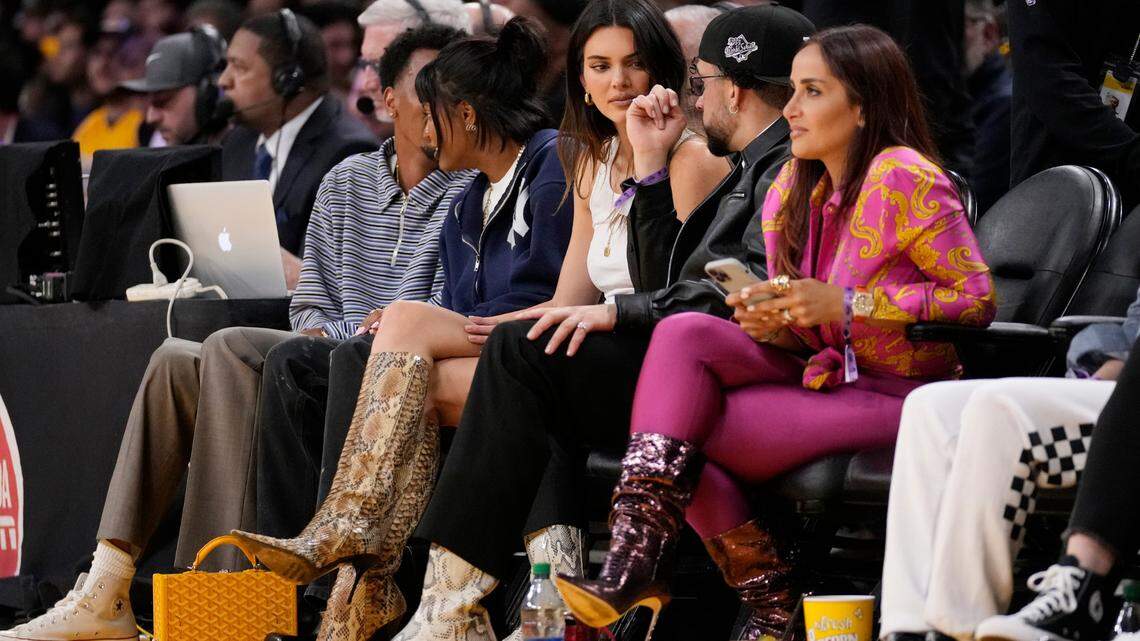 Kendall Jenner, center, sits courtside with Bad Bunny during the second half in Game 6 of an NBA basketball Western Conference semifinal series between the Los Angeles Lakers and the Golden State Warriors Friday, May 12, 2023, in Los Angeles. (AP Photo/Ashley Landis)