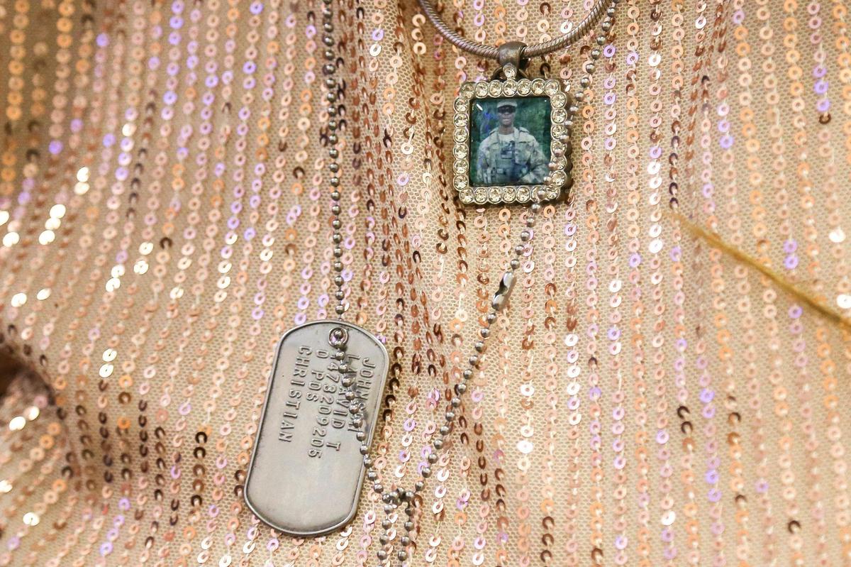 Cowanda Johnson, mother of fallen U.S soldier Sgt. La David T. Johnson, wears the dog tag and a photo of her son around her neck at the City of Miami Gardens Sgt. La David T. Johnson Memorial Day event.