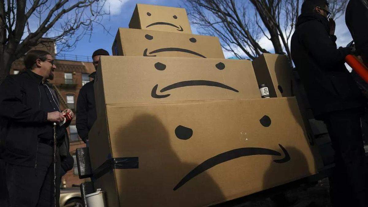 Boxes with the Amazon logo turned into a frowning face are stacked up after a protest against Amazon in Long Island City in Queens, New York.