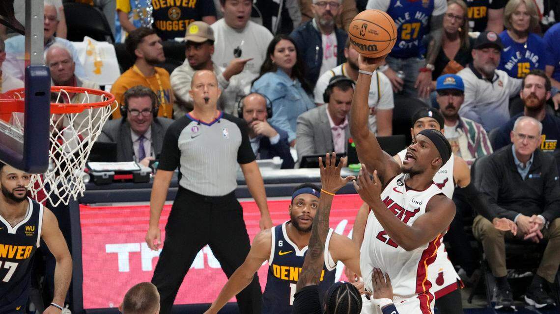 Miami Heat forward Jimmy Butler (22) shoots the ball against Denver Nuggets guard Kentavious Caldwell-Pope (5) during the third quarter in game two of the 2023 NBA Finals at Ball Arena.