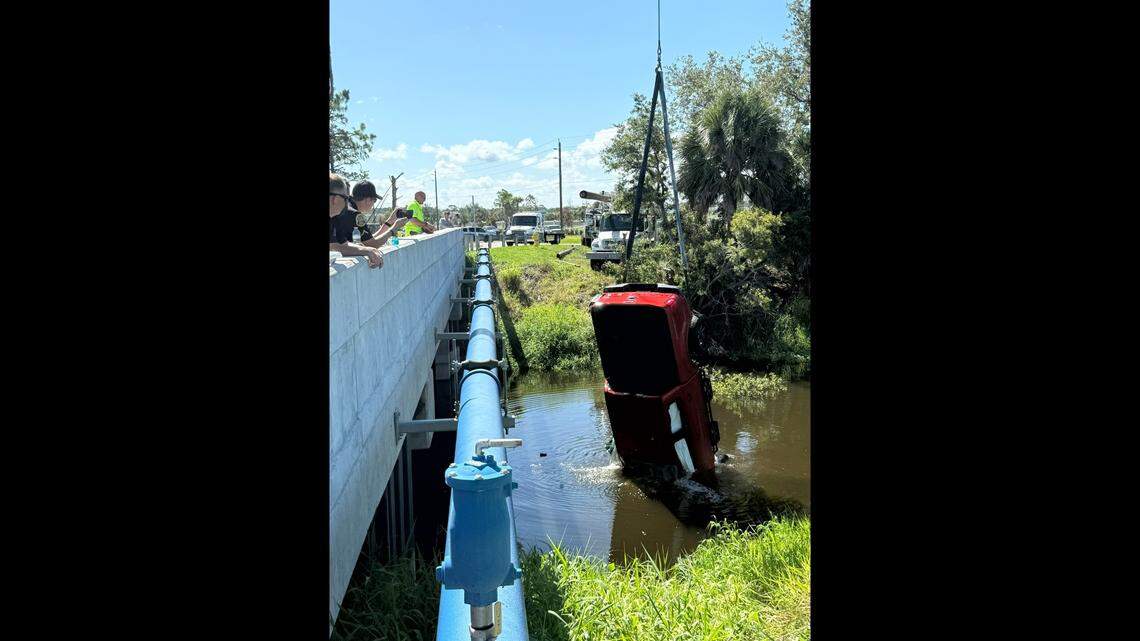 Two large alligators kept rescue divers from reaching the driver of this pickup after it ran off a bridge and landed upside down in a Florida canal, Venice police say.