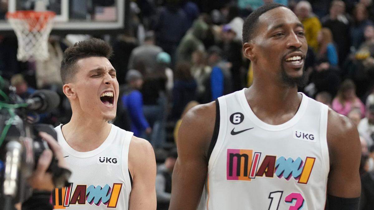 Miami Heat guard Tyler Herro (14) and center Bam Adebayo (13) celebrate Herro’s game-winning shot at the end of the team’s NBA basketball game against the Utah Jazz, Saturday, Dec. 31, 2022, in Salt Lake City.