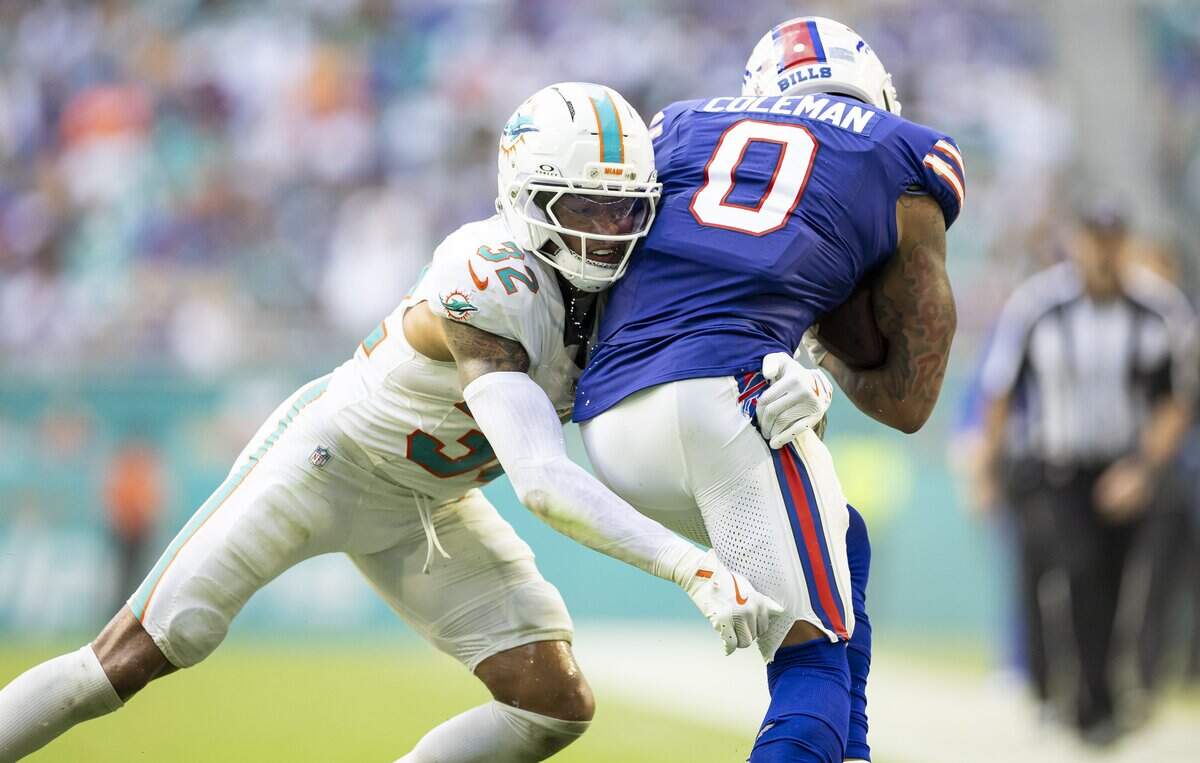 Miami Dolphins cornerback JuJu Brents (32) tackles Buffalo Bills wide receiver Keon Coleman (0) in the second half of their NFL game at Hard Rock Stadium on Sunday, Nov. 9, 2025, in Miami Gardens, Fla.