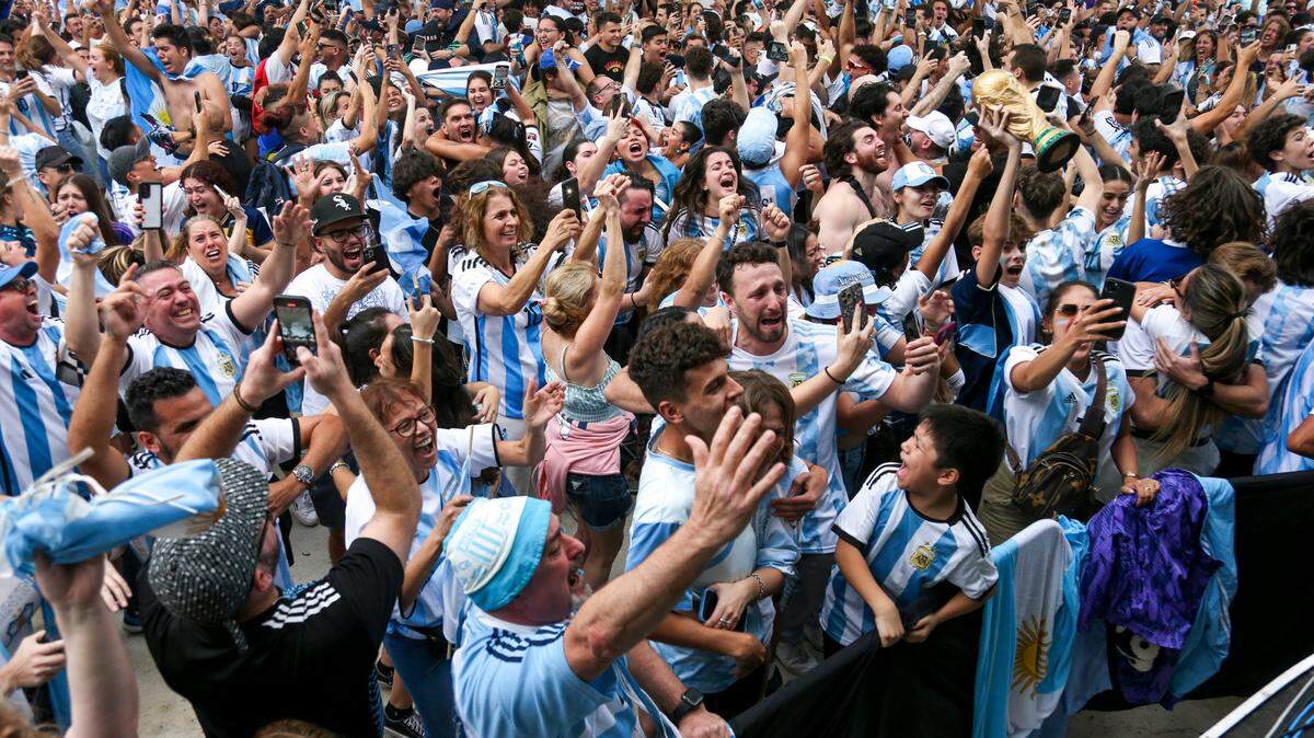 Fans rooting for Argentina celebrate after winning the final against France during a World Cup watch party at the Miami Beach Bandshell in Miami Beach, Florida, Sunday, December 18, 2022.