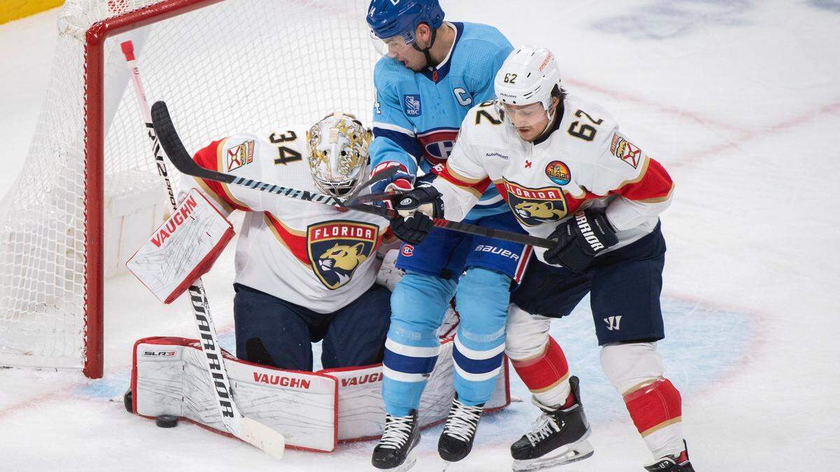 Montreal Canadiens’ Nicke Suzuki, center, moves against Florida Panthers goaltender Alex Lyon (34) as Panthers’ Brandon Montour, right, defends during first-period NHL hockey game action in Montreal, Thursday, Jan. 19, 2023.