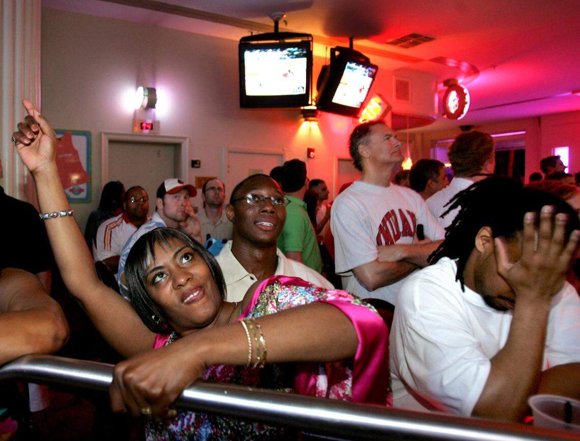 . In 2006, Gators fans and George Mason fans react during a televised basketball game at the Clevelander in South Beach.