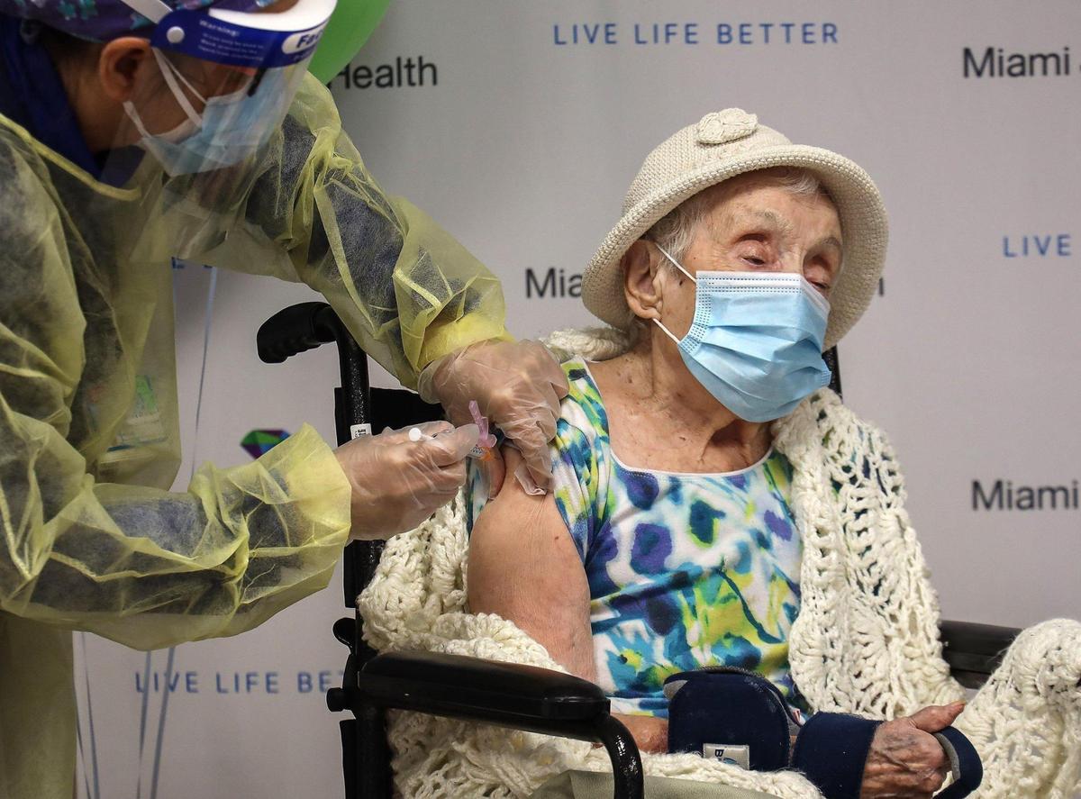 On Monday, Dec. 28, 2020, Miami Jewish Home resident Luz Collazo, 103, who survived the Spanish flu pandemic of 1918, is given a COVID-19 vaccine injection by nurse Cynthia Banada, left, at Miami Jewish Health nursing home in Miami.