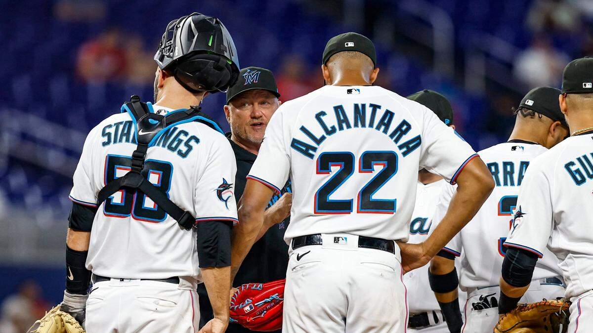 Miami Marlins pitching coach Mel Stottlemyre Jr. speaks with catcher Jacob Stallings (58) and starting pitcher Sandy Alcantara (22) in the second inning during the game against the Atlanta Braves at loanDepot Park in Miami on Tuesday, May 2, 2023.