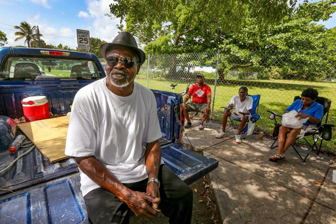 Calvin Williams, a retired restaurant cook and lifelong resident of Miami’s historically Black West Coconut Grove, sits on the back of his truck while chatting with friends outside a convenience story on Grand Avenue and Plaza Street on Wednesday, June 15, 2022.