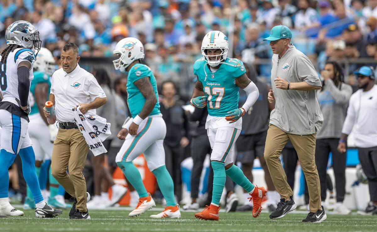Miami Dolphins wide receiver Jaylen Waddle (17) walks off the field with medical staff during the first half of an NFL football game against the Carolina Panthers, Sunday, Oct. 5, 2025, in Charlotte, N.C. Waddle later returned to the game.