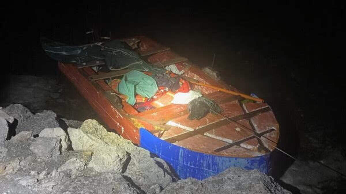 A Cuban migrant boat is tied to rocks near Sombero Beach in the Middle Florida Keys city of Marathon early Thursday morning, Dec. 15, 2022.