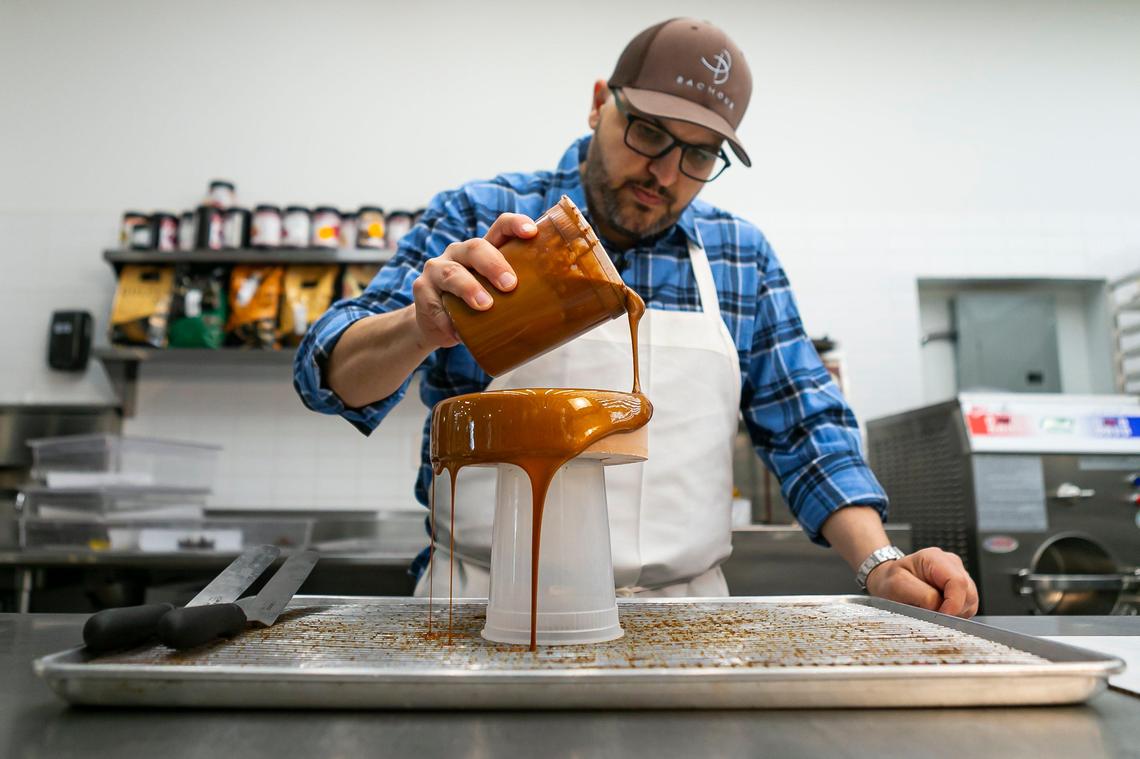Pastry chef Antonio Bachour prepares a mirror glaze cake at his bakery, Bachour, in Coral Gables.