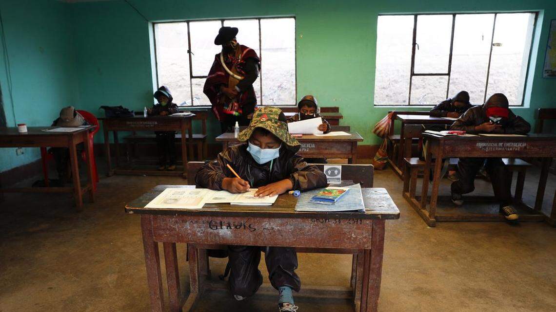 In 2021, an Aymara Indigenous parent watches over students near Jesus de Machaca, Bolivia.