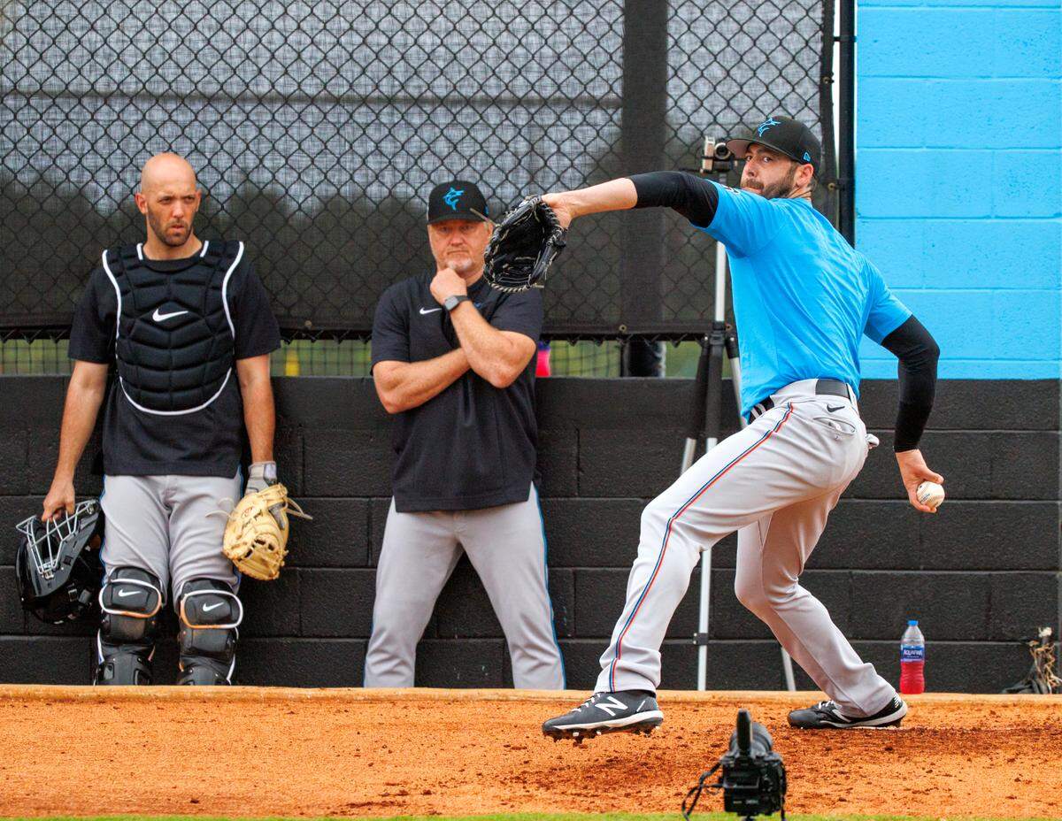Miami Marlins pitching coach Mel Stottlemyre Jr. and catcher Jacob Stallings look as pitcher Dylan Floro throws during their spring training workout at Roger Dean Stadium on Tuesday, March 15, 2022 in Jupiter, FL.