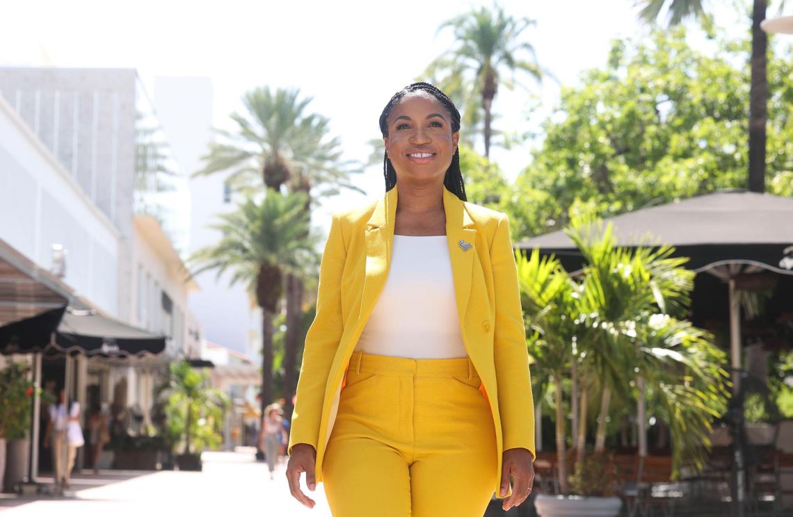 “I didn’t know that I would end up in public service but, looking back on it, it makes sense because I saw my parents do that,” Rickelle Williams said. “Everything I do is a reflection of them.” Above: Williams walks past storefronts on Lincoln Road.