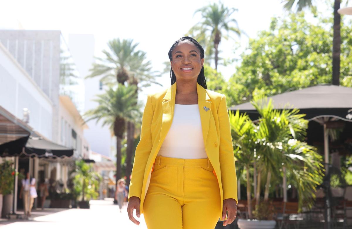 “I didn’t know that I would end up in public service but, looking back on it, it makes sense because I saw my parents do that,” Rickelle Williams said. “Everything I do is a reflection of them.” Above: Williams walks past storefronts on Lincoln Road.