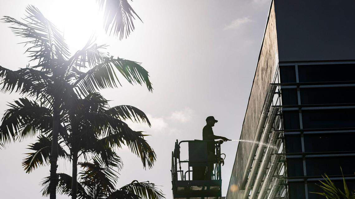 Juan Espinosa cleans the Schwartz Center for Athletic Excellence at the University of Miami on Tuesday, Aug. 8, 2023, in Coral Gables, Fla. The National Weather Service has issued an excessive heat advisory Tuesday in parts of Florida.
