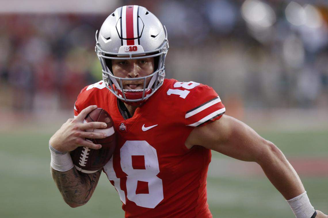 FILE - In this Sept. 22, 2018, file photo, Ohio State quarterback Tate Martell runs against Tulane during an NCAA college football game in Columbus, Ohio. Martell says he is transferring from Ohio State to Miami. Martell announced on Twitter early Wednesday, Jan. 16: “I’m a Hurricane.” Martell had entered his name into the NCAA transfer portal last week and was free to be approached by schools about a potential transfer. (AP Photo/Jay LaPrete, File)