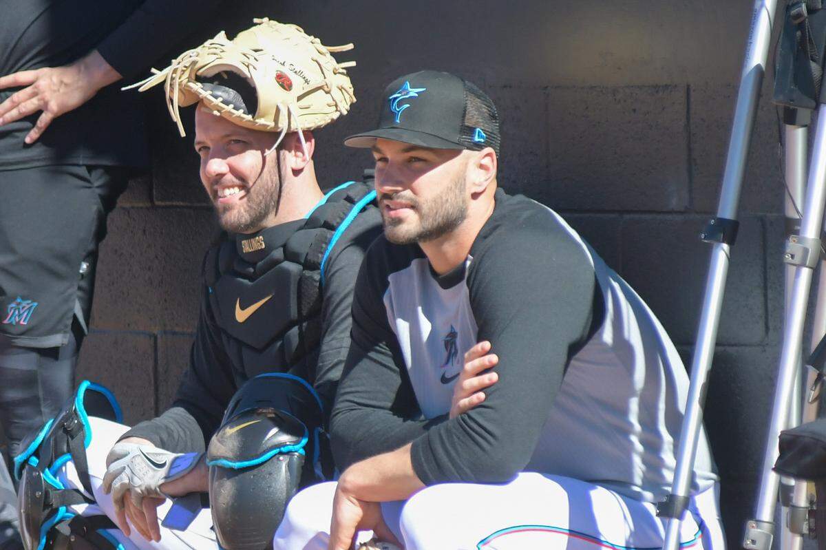 Miami Marlins catcher Jacob Stallings (left) watches bullpen sessions with relief pitcher Tanner Scott (right) on Monday, Feb. 13, 2023, at the Roger Dean Chevrolet Stadium complex in Jupiter, Florida.