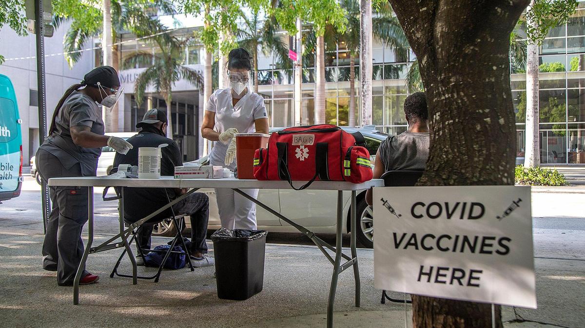 Medical staff vaccinate the homeless population living in downtown Miami at a post set up on Flagler Street with the Johnson & Johnson COVID-19 vaccine as the Miami-Dade County Homeless Trust is teaming up with the Florida Division of Emergency Management to conduct vaccination tours throughout unsheltered homeless hot spots and shelters across Miami-Dade to ensure persons experiencing homelessness have easy access to COVID-19 vaccine, on Tuesday 25, 2021.  