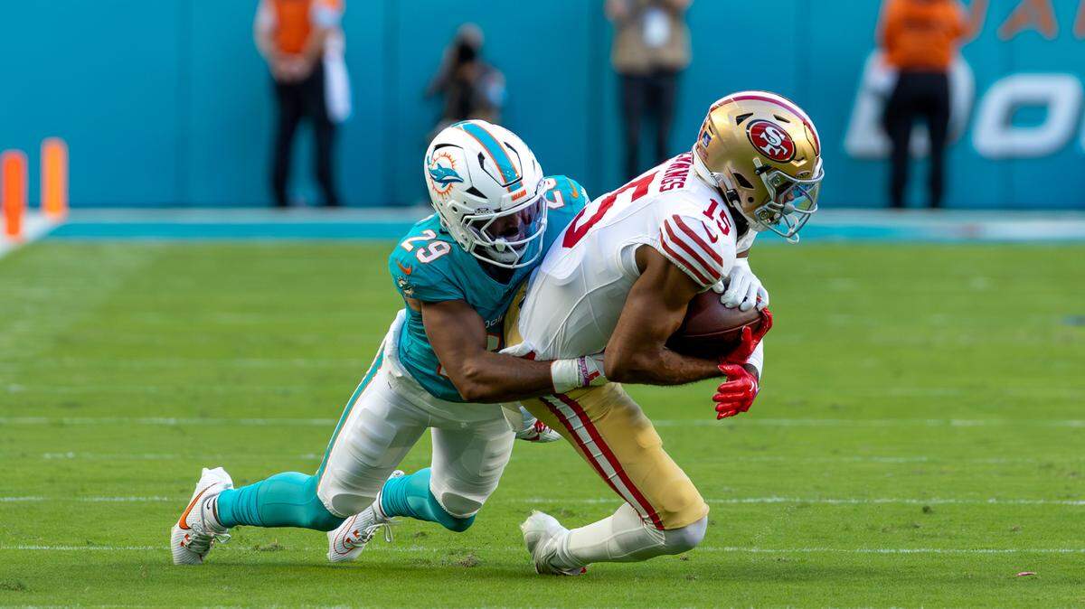 Miami Dolphins cornerback Kendall Fuller (29) brings down San Francisco 49ers wide receiver Jauan Jennings (15) during the first half of their NFL game at Hard Rock Stadium on Sunday, Dec. 22, 2024, in Miami Gardens, Florida.