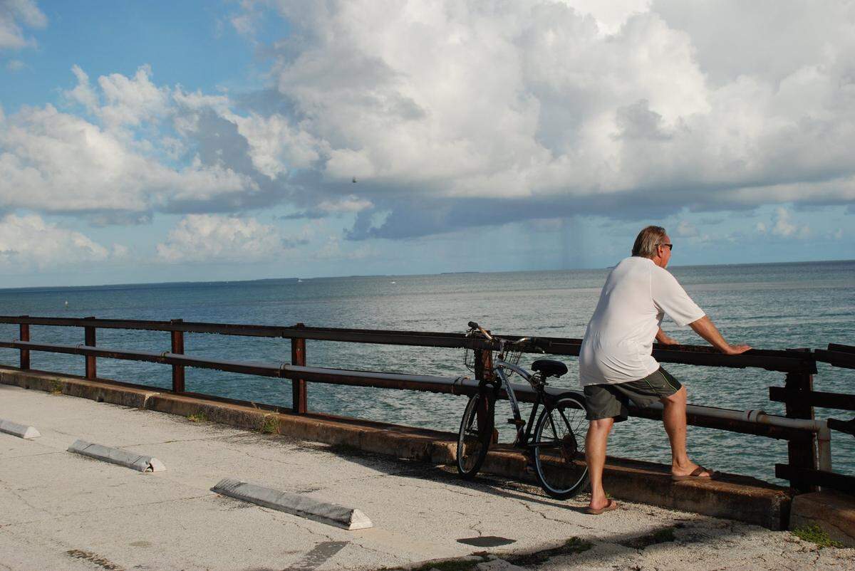 A man stopped his bike ride along the old Seven Mile Bridge to watch a storm brewing on the horizon.