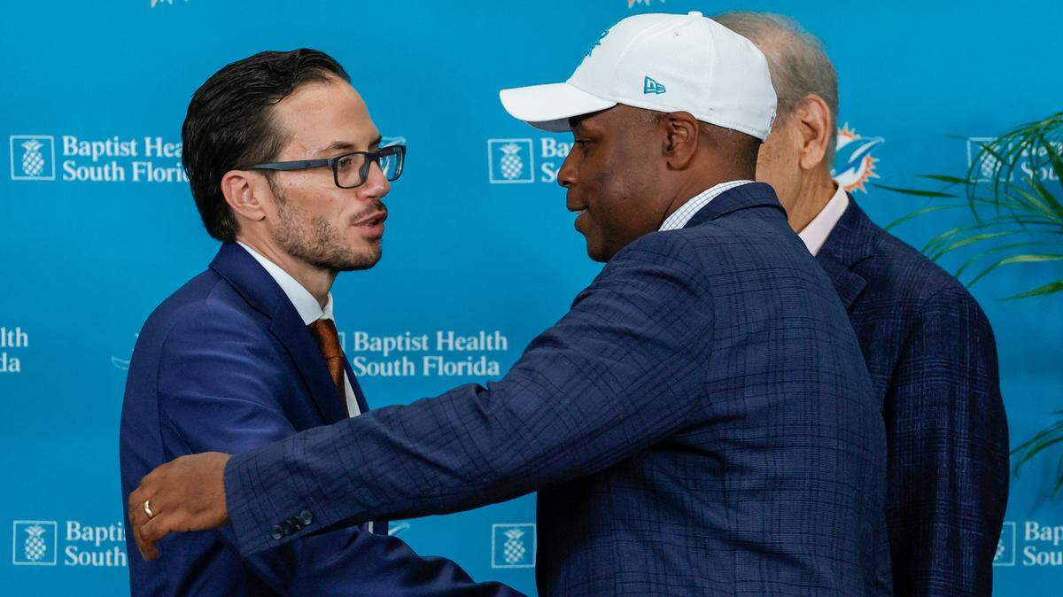 New Miami Dolphins head coach Mike McDaniel shakes hands with Dolphins general manager Chris Grier and Dolphins owner Stephen M. Ross during his introductory press conference at Baptist Health Training Complex in Hard Rock Stadium on Thursday, February 10, 2022 in Miami Gardens, Florida.
