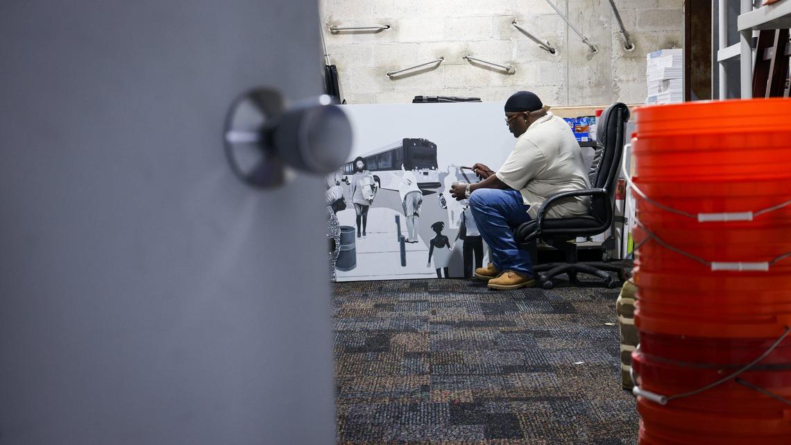 Muralist Addonis Parker works on artwork in his studio in Liberty City. One of the many murals the artist has throughout Miami is “Thunder and Lightning” on the OneUnited Bank Building.