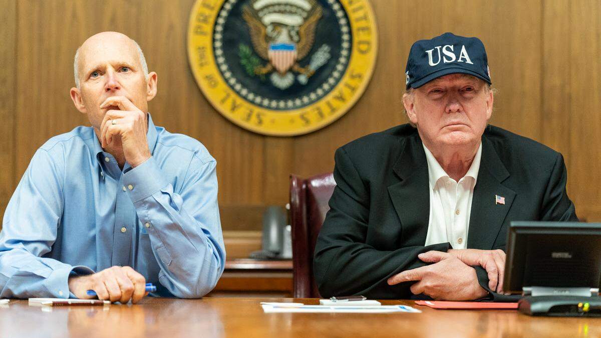 President Donald Trump, joined by U.S. Senator Rick Scott, R-Fla., receives a Federal Emergency Management Agency briefing on Hurricane Dorian as it approaches the U.S. mainland Saturday, Aug. 31, 2019, at Camp David near Thurmont, Md.