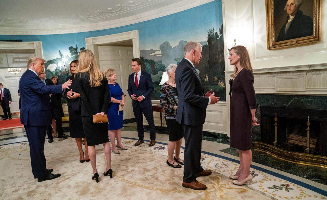 President Donald Trump and first lady Melania Trump with Sen. Kelly Loeffler, a Georgia Republican, left, and Sen. Thom Tillis, a North Carolina Republican, with Judge Amy Coney Barrett, right, at a White House reception on Sept. 26, 2020, the day of Barrett’s nomination. Sen. Josh Hawley, a Missouri Republican, is at center.