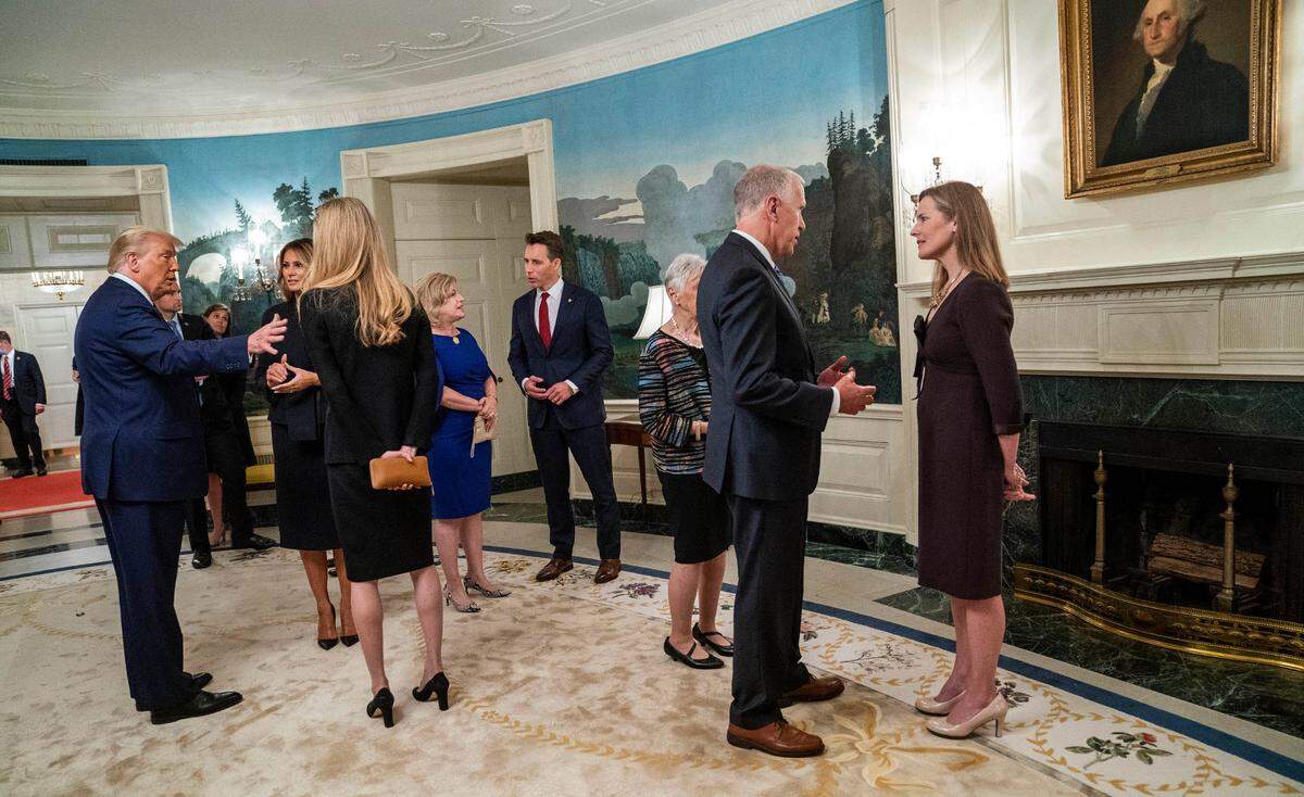 President Donald Trump and first lady Melania Trump with Sen. Kelly Loeffler, a Georgia Republican, left, and Sen. Thom Tillis, a North Carolina Republican, with Judge Amy Coney Barrett, right, at a White House reception on Sept. 26, 2020, the day of Barrett’s nomination. Sen. Josh Hawley, a Missouri Republican, is at center.